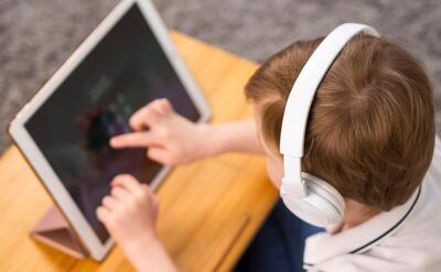 Little boy playing on tablet